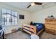 Cozy bedroom with a wooden bed frame, dresser, and a window allowing natural light to filter in at 39286 Hart Cir, Elizabeth, CO 80107