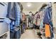 Spacious walk-in closet with ample storage and organization, filled with clothing items and shelves at 39286 Hart Cir, Elizabeth, CO 80107