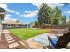 This backyard features a grassy area, patio, and Adirondack chairs perfect for outdoor relaxation and entertaining at 309 W Oak St, Lafayette, CO 80026