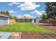 Spacious backyard with well-maintained lawn, rear of house, garage, and fenced perimeter at 309 W Oak St, Lafayette, CO 80026