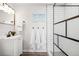 Bright bathroom featuring modern vanity, mirror, and a stylish shower with white subway tiles and modern fixtures at 309 W Oak St, Lafayette, CO 80026