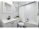 Well-lit bathroom showcasing a tub with white subway tile, a functional toilet, and a modern sink vanity at 309 W Oak St, Lafayette, CO 80026