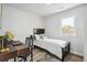 Bright bedroom featuring a dark-wood desk, bed frame, and wood floors, complemented by natural light from a window at 309 W Oak St, Lafayette, CO 80026