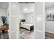 Bedroom with dark-wood floors featuring a sliding door with view of a desk, bed and window at 309 W Oak St, Lafayette, CO 80026
