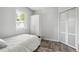 Bright bedroom with wood floors, white trim, and a large window, providing a clean and modern space at 309 W Oak St, Lafayette, CO 80026