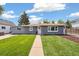 This well-maintained home features a green lawn, walkway, and a lovely facade, offering a welcoming curb appeal at 309 W Oak St, Lafayette, CO 80026