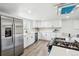 Modern kitchen boasting an island, stainless steel appliances, and white cabinets at 309 W Oak St, Lafayette, CO 80026