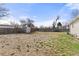 Expansive backyard featuring a storage shed and wooden fence, ideal for pets or children at 5562 Anaheim Way, Denver, CO 80239