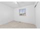 Bedroom featuring a large window and neutral colored carpet at 5562 Anaheim Way, Denver, CO 80239