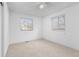 Sunny bedroom featuring neutral carpet, a ceiling fan, and ample natural light at 5562 Anaheim Way, Denver, CO 80239