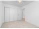 Bedroom featuring neutral carpet and a closet with paneled doors at 5562 Anaheim Way, Denver, CO 80239