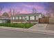 Charming single story home featuring well manicured lawn and long driveway at 5562 Anaheim Way, Denver, CO 80239