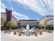 Exterior view of the shopping center and Harkins Theatres with a fountain in front in a pedestrian area at 5562 Anaheim Way, Denver, CO 80239