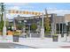 Exterior of Eastbridge shopping center with restaurant and shops and outdoor seating at 5562 Anaheim Way, Denver, CO 80239