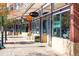 Street view of storefronts with shops and restaurants, and a sign advertising '1st Week FREE' at 5562 Anaheim Way, Denver, CO 80239