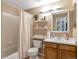 The bathroom includes a tub with shower, a vanity, and decor shelves at 12134 Glencoe St, Thornton, CO 80241