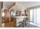 Bright kitchen with stainless steel appliances, breakfast bar seating, and sliding door access to the deck at 12134 Glencoe St, Thornton, CO 80241