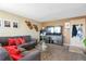 Cozy living room featuring a comfortable sectional sofa, a large TV, and neutral decor at 12134 Glencoe St, Thornton, CO 80241