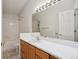 The bathroom showcases ample counter space, a mirrored wall, and a shower-tub combo for added convenience at 2846 W Centennial Dr # E, Littleton, CO 80123