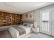 Comfortable bedroom with built-in bookshelves and a private balcony at 2846 W Centennial Dr # E, Littleton, CO 80123