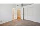 The bedroom features multiple closets and neutral carpet that would be a blank canvas for the new homeowner at 2846 W Centennial Dr # E, Littleton, CO 80123