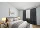 Serene bedroom featuring a plush bed, soft lighting, and elegant gray curtains at 2846 W Centennial Dr # E, Littleton, CO 80123