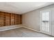 Bonus room featuring custom built-in shelving and access to the outdoors through the double doors at 2846 W Centennial Dr # E, Littleton, CO 80123