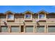 Townhome exterior with attached garages and manicured landscaping at 2846 W Centennial Dr # E, Littleton, CO 80123