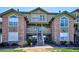 Inviting condo featuring stone accents, private balconies, and well-maintained landscaping at 2846 W Centennial Dr # E, Littleton, CO 80123