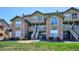 Condo building with stone accents, balconies, and a lush green lawn at 2846 W Centennial Dr # E, Littleton, CO 80123