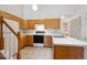 Functional kitchen featuring white countertops, wood cabinets, and tiled flooring at 2846 W Centennial Dr # E, Littleton, CO 80123