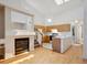 Spacious living area featuring a fireplace, adjacent to a bright kitchen with an island at 2846 W Centennial Dr # E, Littleton, CO 80123