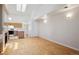 Bright living area with a skylight, hardwood floors, and an open layout to the kitchen at 2846 W Centennial Dr # E, Littleton, CO 80123
