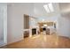 Open-concept living area with skylights, fireplace, and an adjoining kitchen at 2846 W Centennial Dr # E, Littleton, CO 80123
