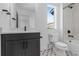 Modern bathroom with a white vanity, geometric floor tiles, and tub shower at 14245 Currant St, Broomfield, CO 80020