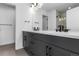 Modern bathroom with double vanity, grey cabinets and a walk-in shower at 14245 Currant St, Broomfield, CO 80020