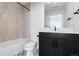 Bathroom features a modern vanity, integrated sink, and a bathtub with stylish tile surround at 14245 Currant St, Broomfield, CO 80020