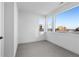 A bedroom featuring three large windows offering abundant natural light and gray carpeting at 14245 Currant St, Broomfield, CO 80020