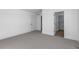 Neutral bedroom with grey carpet and two entrances to a bathroom and closet at 14245 Currant St, Broomfield, CO 80020