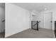 A hallway is featuring gray carpeting and wooden railing on the stairway at 14245 Currant St, Broomfield, CO 80020