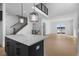 Modern kitchen with central island with black cabinets and open concept living room at 14245 Currant St, Broomfield, CO 80020