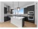Modern kitchen with stainless steel appliances, a central island and grey cabinets at 14245 Currant St, Broomfield, CO 80020
