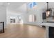 Open-concept living room with access to the backyard, white walls, and large windows at 14245 Currant St, Broomfield, CO 80020