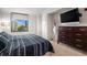 Bright bedroom featuring a city view, neutral walls, and wooden dresser at 8100 E. Union Ave # 409, Denver, CO 80237