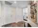 Inviting entryway leading to laundry area with marble floors and warm lighting at 8100 E. Union Ave # 409, Denver, CO 80237