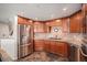 Well-lit kitchen with stainless steel appliances, granite countertops, and custom cabinetry at 8100 E. Union Ave # 409, Denver, CO 80237