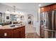 Bright kitchen with stainless steel refrigerator and an open view into the living area at 8100 E. Union Ave # 409, Denver, CO 80237