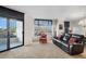 Spacious living room with balcony access, large windows, and comfortable seating at 8100 E. Union Ave # 409, Denver, CO 80237