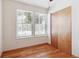 Well-lit bedroom with hardwood floors and a double window providing ample natural light at 4656 S Dillon Ct # D, Aurora, CO 80015