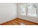 Clean, empty bedroom with gleaming hardwood floors and lots of natural light from the windows at 4656 S Dillon Ct # D, Aurora, CO 80015